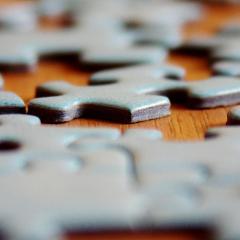 jigsaw pieces on table; Image via Pixabay, CC0 Public Domain